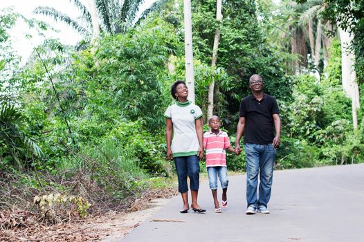 this couple in countryside ride with their child in their midst.