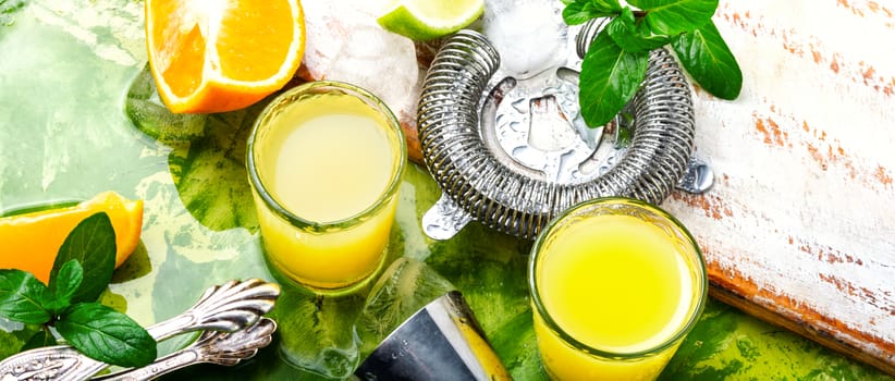 Orange cocktail with lime slice and ice.Glass of orange drink