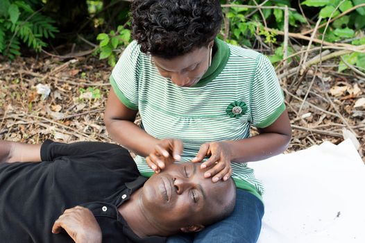 this man put his head on knees his wife during picnic