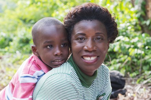 this happy mother carries her son on back