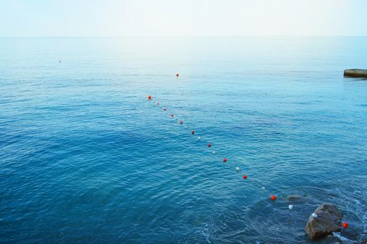 Separation buoys in the sea for safe swimming on the beach.