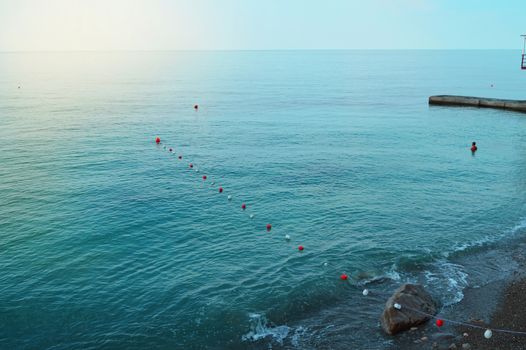 Separation buoys in the sea for safe swimming on the beach.