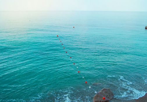 Separation buoys in the sea for safe swimming on the beach.