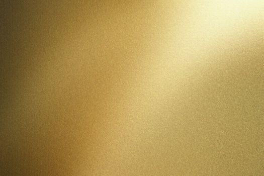 Light shining on gold metal sheet, abstract texture background