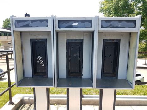 old phone booths worn and weathered with no phones