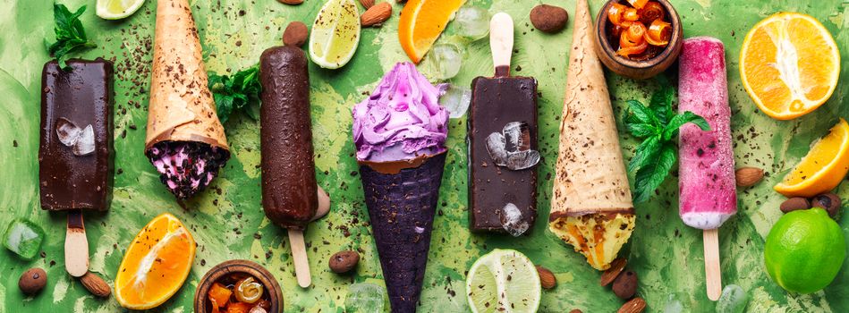 Different types of ice cream in a waffle cone and popsicle.Sweet dessert