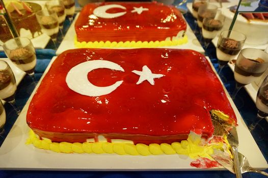 Cake with icing painted Turkish flag, restaurant food concept in the hotel.