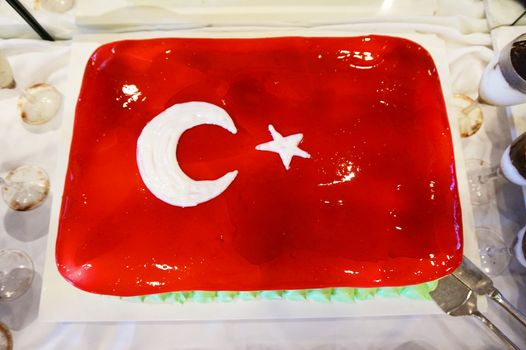 Cake with icing painted Turkish flag, restaurant food concept in the hotel.