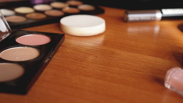 Decorative cosmetics on wooden background top and back view