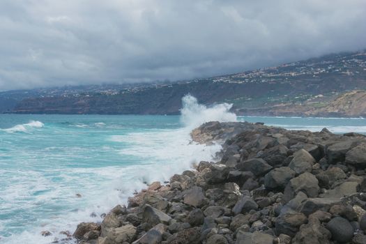 Ocean waves crashing against rocks. landscape on tenerife