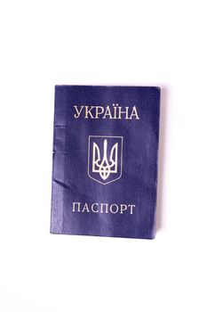 Blue Ukrainian passport isolated on white background. Passport is old and damaged a little bit. Stock photo of travel documents.