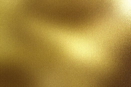 Glowing brushed gold metal wall surface, abstract texture background