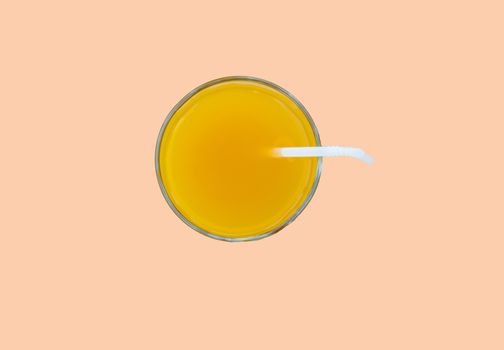 Summer drink - freshly squeezed orange juice in a glass with a straw tube, top view, isolated on a pink background with clipping, minimalism style.