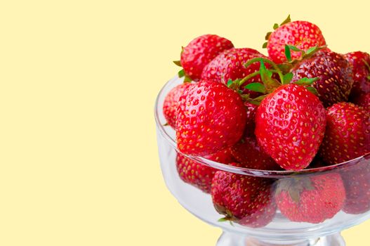 Glass bowl with fresh ripe strawberries, space for text, copy space isolated on yellow background, layout, clipping.