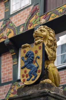 figure of a lion with the coat of arms on the street in the city Celle, Germany