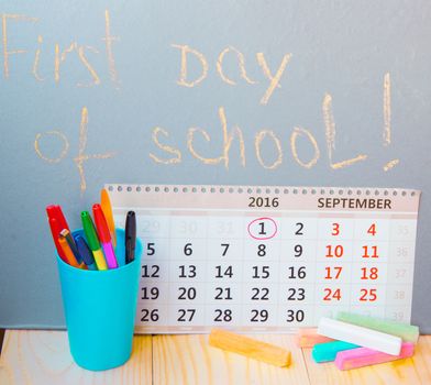 First day at school writing on the blackboard, calendar, stationery.