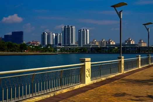 Putrajaya lake promenade with residential area and skyscrapers