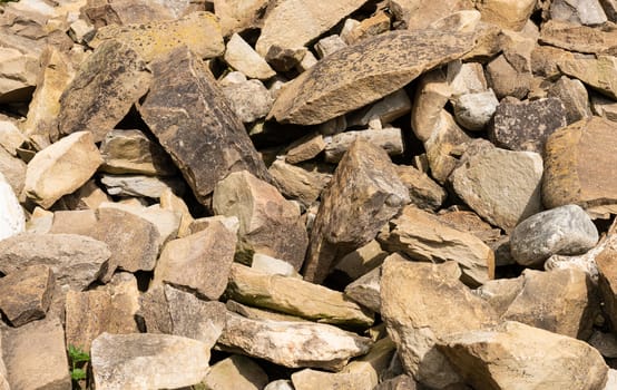 Pile of medieval wall stones or rocks  of irregular sizes.