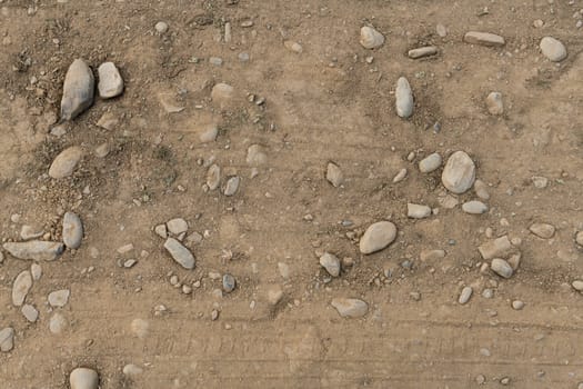 Dirt or soil with rocks close-up, environmental texture, pattern.
