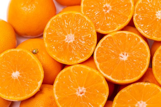 Top view of round cut slices of ripe juicy organic mandarin oranges on a white background. Vitamins healthy lifestyle vegan super foods concept.