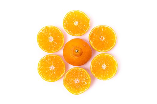 Top view of round cut slices of ripe juicy organic mandarin oranges on a white background. Vitamins healthy lifestyle vegan super foods concept.