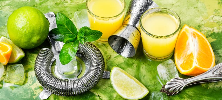 Orange cocktail with lime slice and ice.Glass of orange drink