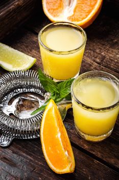 Glass of orange drink.Alcoholic drinks on rustic wood background.Drink background