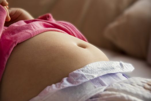 belly, tummy of a small child close up photo. young skin with a visible navel