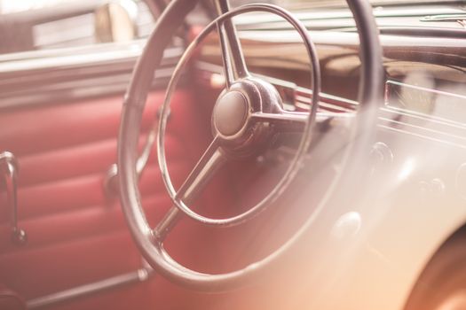 Classic vintage car interior, close up on steering wheel, dasboard,