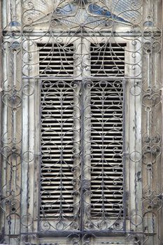 Wooden old window with iron bars