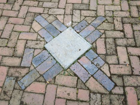 red and blue bricks and cement square on ground or floor