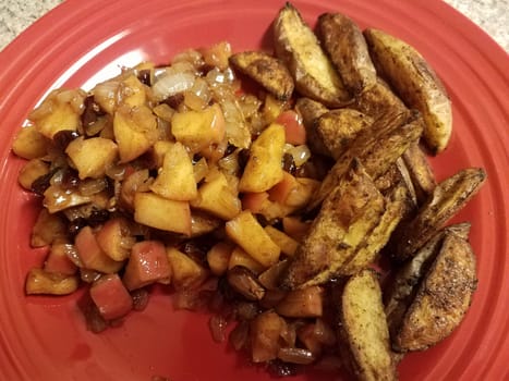 potatoes with pile of apples and onions on red plate