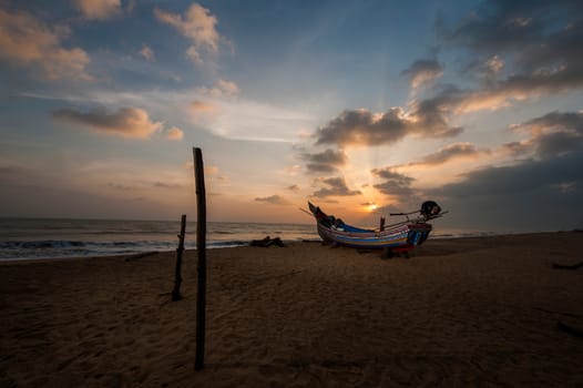 Thai long-tailed boat rest in the beach at sunrise sea in southern of Thailand