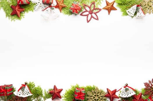 Top view of Christmas background, template with decorations of balls, gift boxes, white bells on fir tree on with white background with copy space, ornaments for new year greetings.