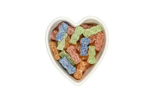 Variety of different color sweet and sour candy or sugar junk food in a heart shaped bowl  isolated on white with clipping path at ALL sizes.