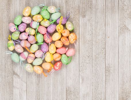 Happy Easter colorful foam eggs on a wooden background.