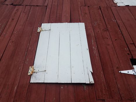 red wood barn or building with white closed doors