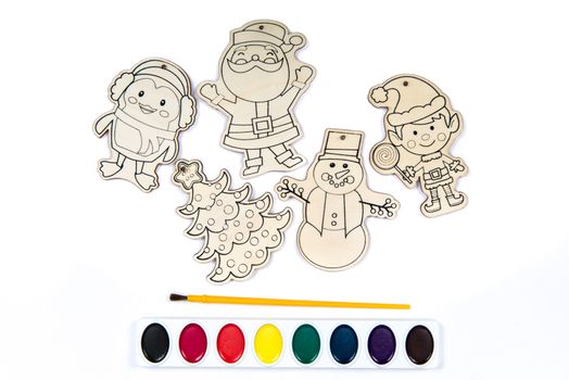 Wood craft shapes or wooden cutouts including Santa, Christmas Tree, Penguin, Elf and Snowman with paint brush and watercolor set.