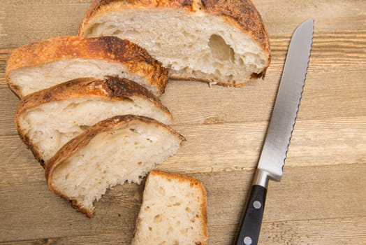 Freshly cut slices of white artisan sourdough bread on isolated a white background.