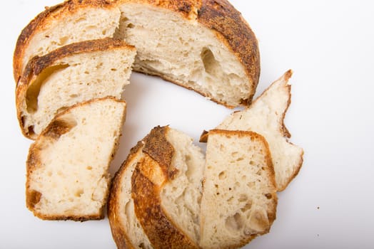 Freshly cut slices of white artisan sourdough bread on isolated a white background.