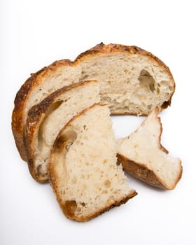 Freshly cut slices of white artisan sourdough bread on isolated a white background.