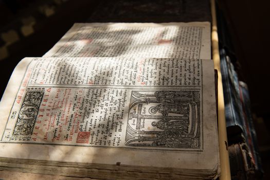 Close up of old Christian manuscript written in Cyrillic on church pulpit.