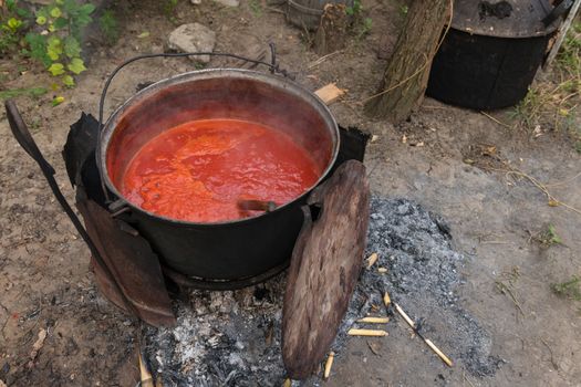 Making tomato sauce the old fashioned way in a large pot.