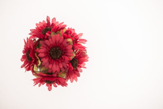 Reusable artificial flowers made from cloth and plastic.