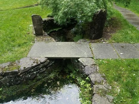 stone path and tiles and bridge over water or pond