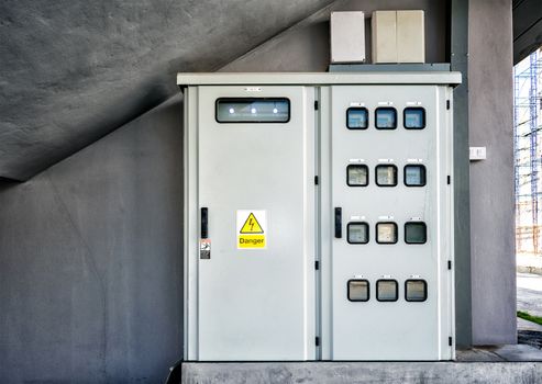 Functioning Electric Meter Panel with a Danger Sign