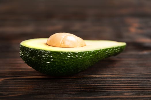 A sliced avocado on a cutting board