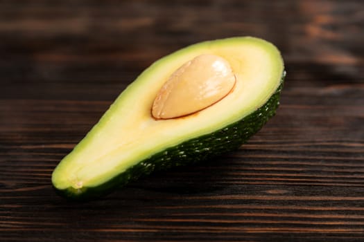 A sliced avocado on a cutting board