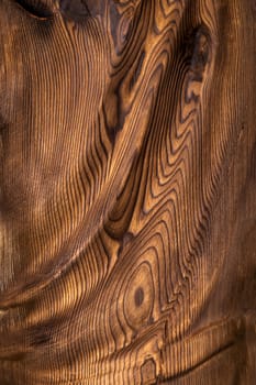 Brown wavy wooden surface. Art processing of a tree