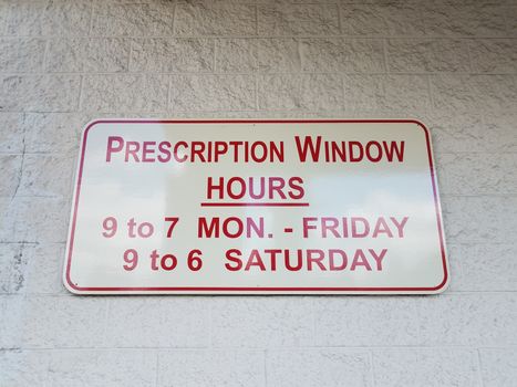 prescription window hours sign times and days on wall